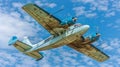 Bottom view - twin prop cargo plane on sky background Royalty Free Stock Photo