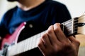 Bottom view of an unrecognizable man playing an electric guitar. Highly contrasted,view from the headstock of the guitar Royalty Free Stock Photo