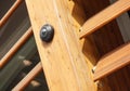 Bottom view of video camera screwed to the corner of the log house at the sunny spring day Royalty Free Stock Photo