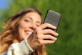 Bottom view of a woman hand texting on a smart phone