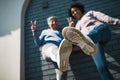 Bottom view, women shoes and closeup with portrait, peace sign and smile outdoor. Wall, mature female friends and Royalty Free Stock Photo