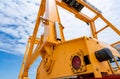 Bottom view of yellow gantry crane against blue sky at port. Gantry crane for cargo and construction industry. Overhead crane for Royalty Free Stock Photo