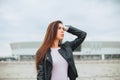 Bottom view of young attractive woman biker wearing bike safety helmet while standing at empty stadium