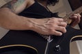 Bottom view of a young man playing a black and yellow electric guitar at indoor Royalty Free Stock Photo