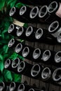 The bottom of the wine bottles is displayed on shelves in the open air. Creative dark and textured abstract background. Alcohol Royalty Free Stock Photo