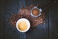 Bottomless filter with grind beans on a wooden black table and cup of espresso coffee. Roasted coffee beans. Espresso coffee extra Royalty Free Stock Photo