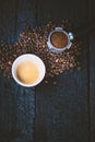 Bottomless filter with grind beans on a wooden black table and cup of espresso coffee. Roasted coffee beans. Espresso coffee extra Royalty Free Stock Photo