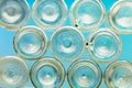 Bottoms of empty glass bottles on blue background Royalty Free Stock Photo