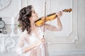 Woman with violin in white peignoir. Boudoir. seductive Royalty Free Stock Photo