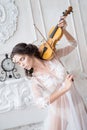 Woman with violin in white peignoir. Boudoir. seductive Royalty Free Stock Photo