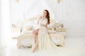 Boudoir Bride`s morning. Cute red-haired girl in her wedding day