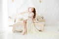 Boudoir Bride`s morning. Cute red-haired girl in her wedding day