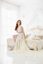 Boudoir Bride`s morning. Cute red-haired girl in her wedding day