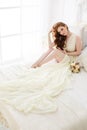 Boudoir Bride`s morning. Cute red-haired girl in her wedding day