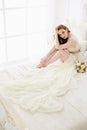 Boudoir Bride`s morning. Cute red-haired girl in her wedding day