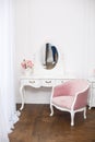 Boudoir room with pink soft armchair.