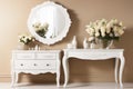 Boudoir white table with a bouquet of flowers and a mirror against a beige wall. Bedroom interior elements. A place to create