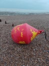 A buoy ,sea side , storms, ocean, currents ,washed up on shore,on the beach,oh
