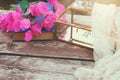 bougainvillea flower, delicate scarf and glass box on old wooden table outdoor in the park