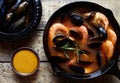 Bouillabaisse fish soup with prawns, mussels tomato, lobster. Sauce Rouille. Rustic style background. Flat lay.