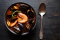 Bouillabaisse soup. Fish stew with mussels, shrimp, tomato and lobster. Traditional dish in France. Dark rustic style.