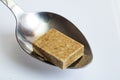 Bouillon cube in a spoon close up Royalty Free Stock Photo