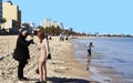 Boujaafar beach in winter with blue skies and sunshine with an elderly Tunisian couple in the foreground