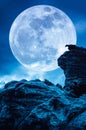 Boulder against blue sky with clouds and beautiful full moon at Royalty Free Stock Photo