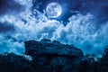 Boulder against blue sky with clouds and beautiful full moon at Royalty Free Stock Photo