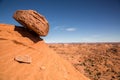 Boulder balanced on edge over sandstone cliff Royalty Free Stock Photo