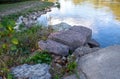 Boulders and cement along the river edge Royalty Free Stock Photo