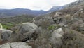 Boulders at foot of mountain. Shot. Drone view of extreme flight over boulders and rocks on mountain slopes. Natural