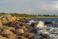 Boulders, forest, shore, evening light, sunset, clouds, blue sky and rainbow on the Baltic Sea Royalty Free Stock Photo