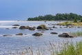 Boulders, forest, shore, evening light, sunset, clouds, blue sky and rainbow on the Baltic Sea. Royalty Free Stock Photo