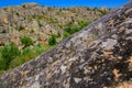 Boulders overgrown with moss in a canyon with rocks. Royalty Free Stock Photo