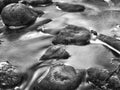 Boulders and rocks in a stream, black and white. Marine and ocean theme. Royalty Free Stock Photo