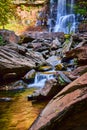 Boulders surrounded beautiful peaceful waterfalls small and large pouring over rocky cliffs