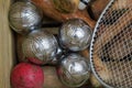 Boules balls and croquet mallets and tennis rackets in a box viewed from above Royalty Free Stock Photo