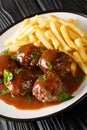 Boulets liegeois is a popular dish served all over Belgium made of meatballs swimming in an apple and onion gravy served with