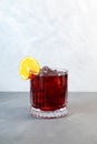 Boulevardier cocktail with ice cubes and orange slice. Classic alcoholic drink composed of whiskey, sweet vermouth, and Campari.