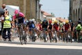 A rider for the Lampre Merida team leads the chasing pack through the main square of Royalty Free Stock Photo