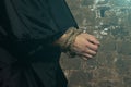 Bound monk hands without rosary on dark background Royalty Free Stock Photo