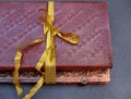 Bound notebook in leather and tied with a gold ribbon Royalty Free Stock Photo