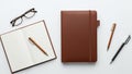 Bound notebook and an open lined notebook with a brown pen on Royalty Free Stock Photo