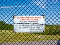 Boundary fence for security with warning signs at Manchester International airport Royalty Free Stock Photo