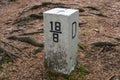 Boundary marker border stone in forest border, mountains Royalty Free Stock Photo