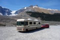 A bounder and dinghy parked with the rockies in the background