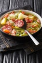 Bouneschlupp is a traditional Luxemburgish green bean soup with potatoes  bacon  and onions close-up in a plate. Vertical Royalty Free Stock Photo