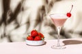 Bounty martini summer cocktail drink with vodka, liqueur, cream, strawberries and ice in glass with red cocktail cherry. Beige Royalty Free Stock Photo