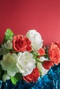 Bouquet of artificial flowers on a red background with copy space. Selective focus Royalty Free Stock Photo